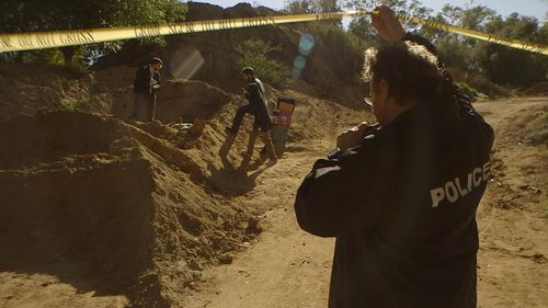 Glenn playing a Police Officer in 