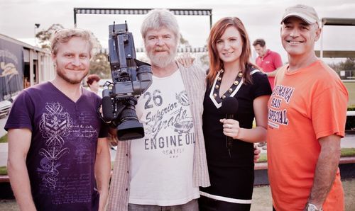 Producer Mel Poole cameos as a reporter on set of Nice Package