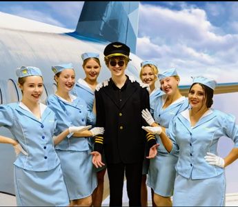 Ashlyn Ford (left) as Stewardess Jane in Catch Me If You Can
