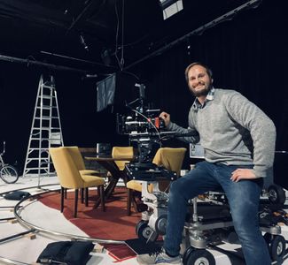Director Micah Knapp - sitting on a Chapman SuperPeewee dolly on set