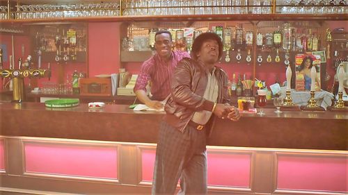 Screen shot taken from the UK Sitcom 'In the Long Run 3' Episode 2. Kenny-Lee Mbanefo playing the role of the Milton Arm