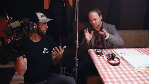 Director Kelly King and cinematographer Ken Wales talk through a shot on set.
