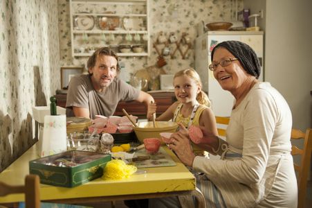 Jennifer (Orla Hill) cooking with Marion (Vanessa Redgrave) and James (Christopher Eccleston)