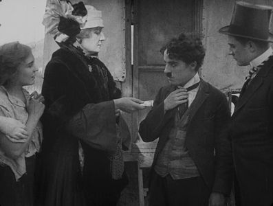 Charles Chaplin, Lloyd Bacon, Charlotte Mineau, and Edna Purviance in The Vagabond (1916)
