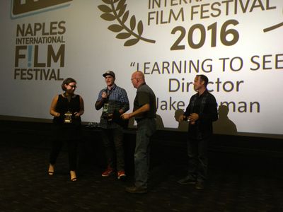 Director Jake Oelman and his father Robert Oelman accepting the Neapolitan Award at the Naples International Film Festiv