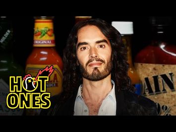 Russell Brand Serenades Superfan Brett Baker While Eating Spicy Wings | Hot Ones
